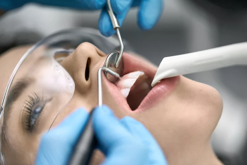 Pretty womans teeth cleaning in dental clinic